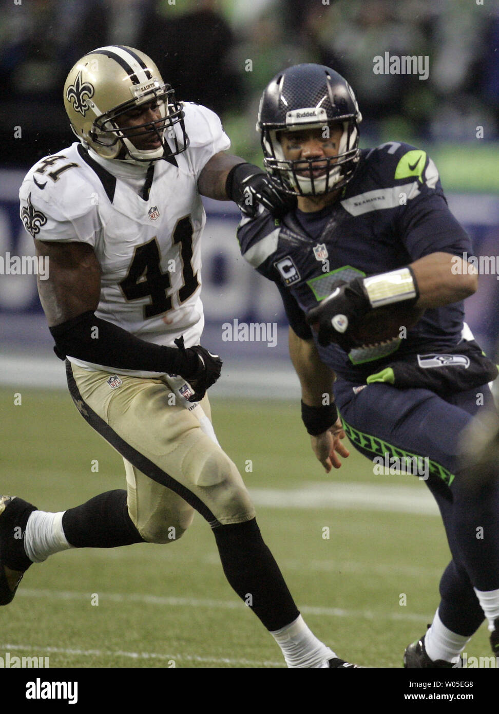 A stunned New Orleans Saints' Roman Harper walks off the field as the  Seattle Seahawks' celebrate their 41-36 win over the Super Bowl Defending  Champions in the NFC's wild-card playoff game on