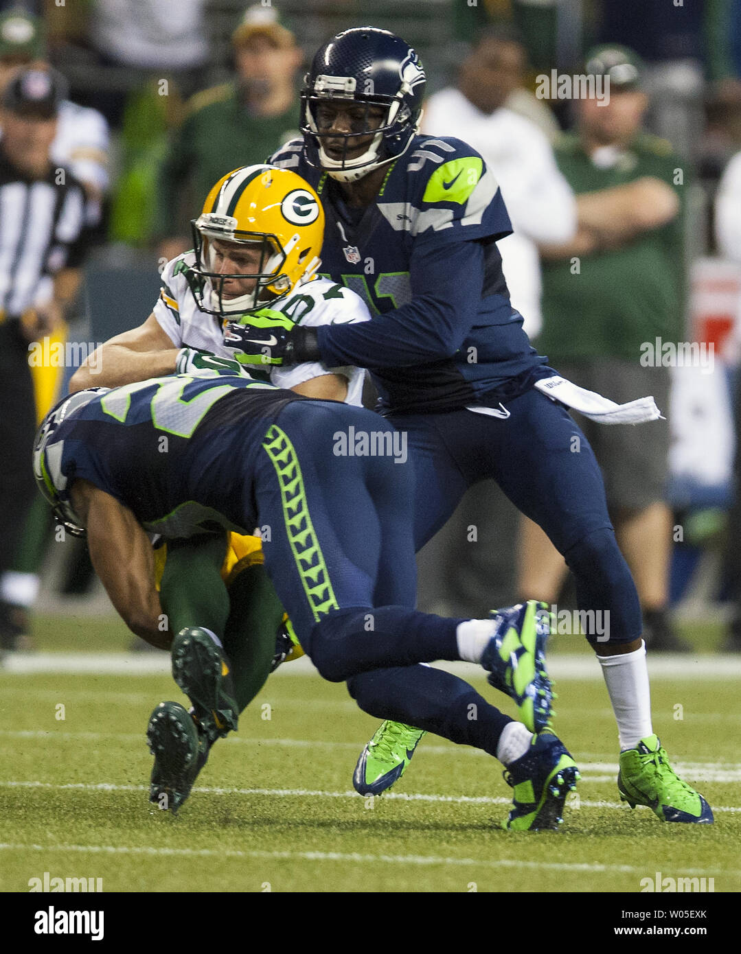 Seattle Seahawks defensive backs Richard Thomas (25) and Byron Maxwell tackle Green Bay Packers wide receiver Jordy nelson (87) during the third quarter of the NFL Kickoff held at CenturyLink Field September 4, 2014 in Seattle. The Seahawks beat the Packers 36-16.   UPI/Jim Bryant Stock Photo