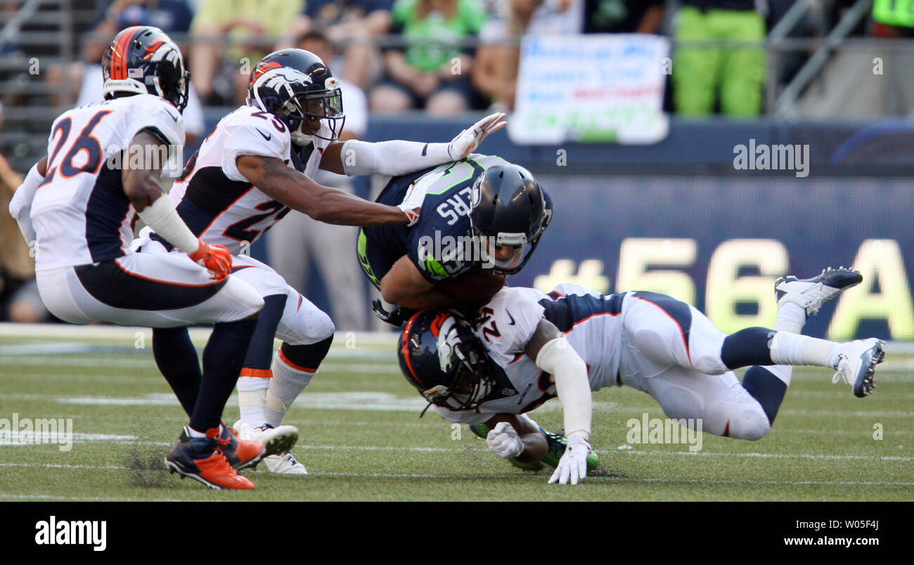 Seattle Seahawks  wide receiver Bryan Walters (19) is tackled Denver Broncos cornerback Bradley Roby (29), Chris Harris Jr., and Rahim Moore (26) after catching a pass for an 11-yard gain in the fourth quarter at CenturyLink Field in Seattle, Washington on September 21, 2014. The Seahawks won 26-20 in overtime.    UPI/Jim Bryant Stock Photo