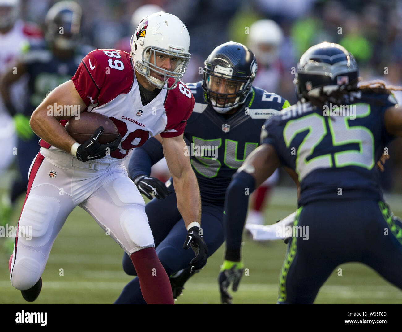 Seattle Seahawks defenders Bobby Wagner, (54), Marcus Trufant, (23)  cerebrate with Richard Sherman after he intercepted a New England Patriots  pass at CenturyLink Field in Seattle, Washington on October 14, 2012. With