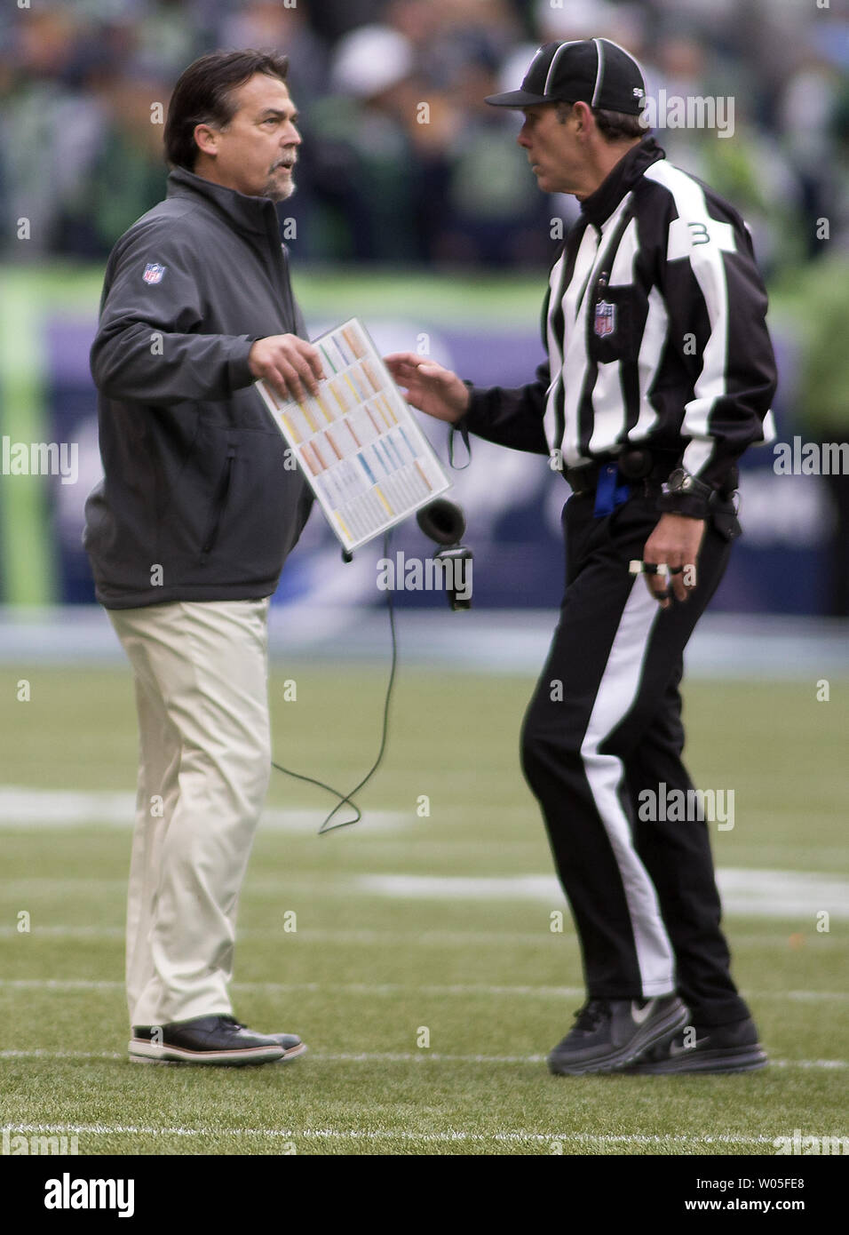 St. Louis Rams head coach Jeff Fisher questions side judge Scott Edwards (3) over ball placement in the second quarter at CenturyLink Field in Seattle, Washington on December 28, 2014.  The Seattle Seahawks beat the St. Louis Rams 20-6.   UPI/Jim Bryant Stock Photo