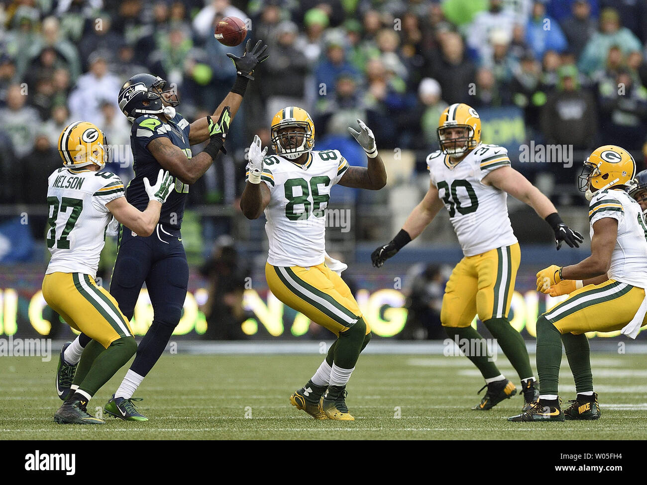 Chris Matthews (13) of the Seattle Seahawks recovers an onside kick against Jordy Nelson (87), Brandon Bostick (86), and John Kuhn (30) of the Green Bay Packers  in the NFC Championship game at CenturyLink Field in Seattle, Washington on January 18, 2015.  Seattle won 28-22. Photo by Troy Wayrynen/UPI Stock Photo