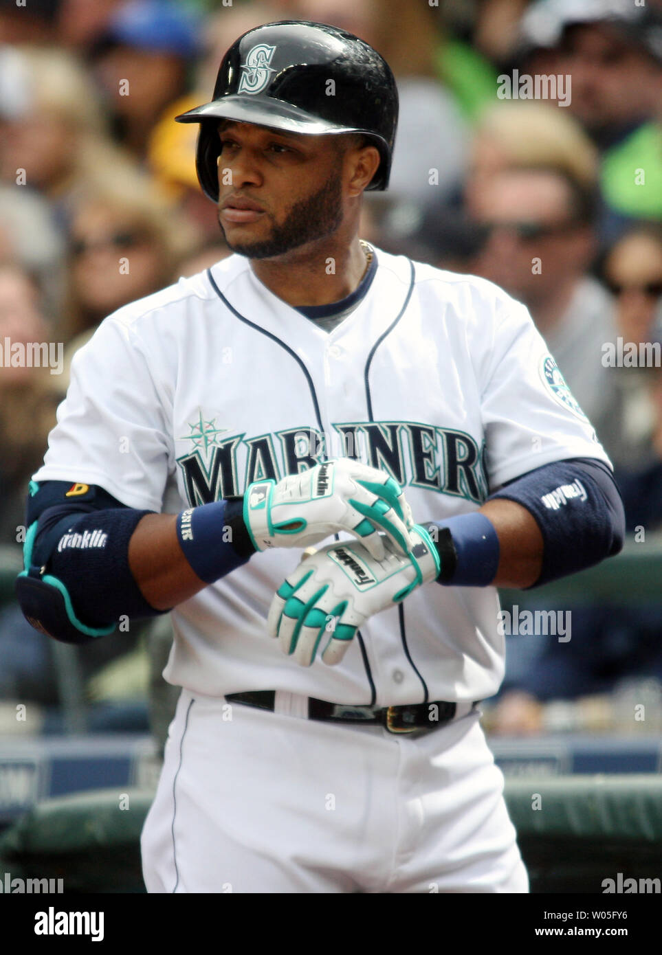 Seattle Mariners' Robinson Cano adjust his batting gloves before