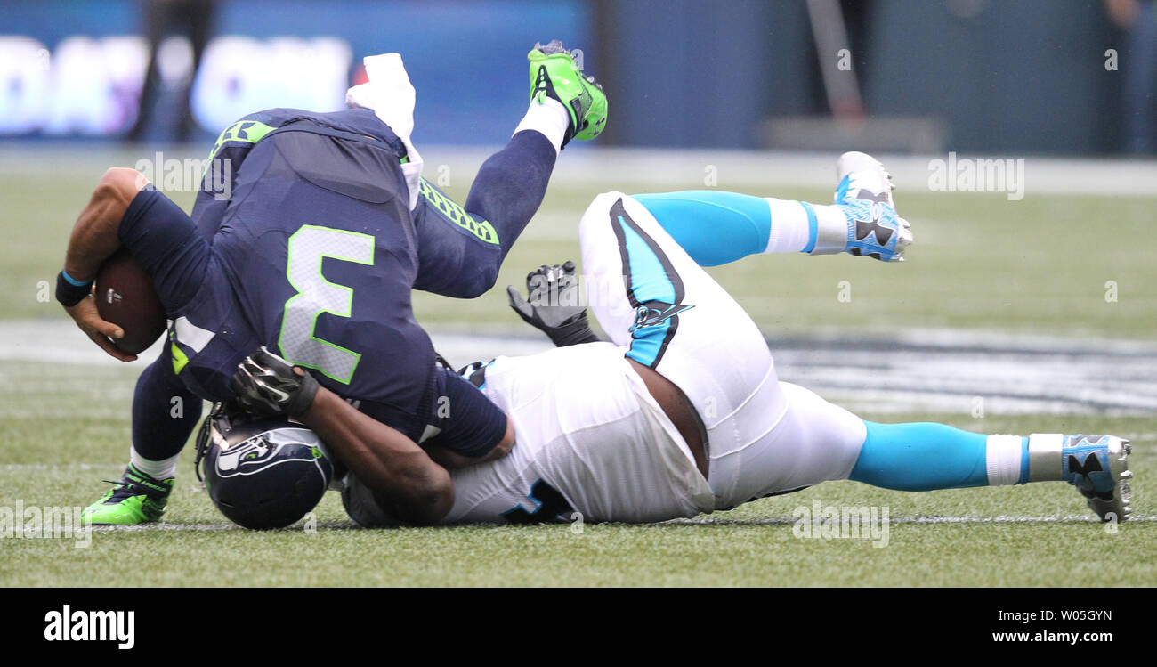 Seattle Seahawks quarterback Russell Wilson is turned on his head by Carolina Panthers defensive end Kony Ealy at CenturyLink Field in Seattle on October 18, 2015. The Panthers came from behind with 32 seconds remaining in the 4th Quarter to beat the Seahawks 27-23.   Photo by Jim Bryant/UPI Stock Photo