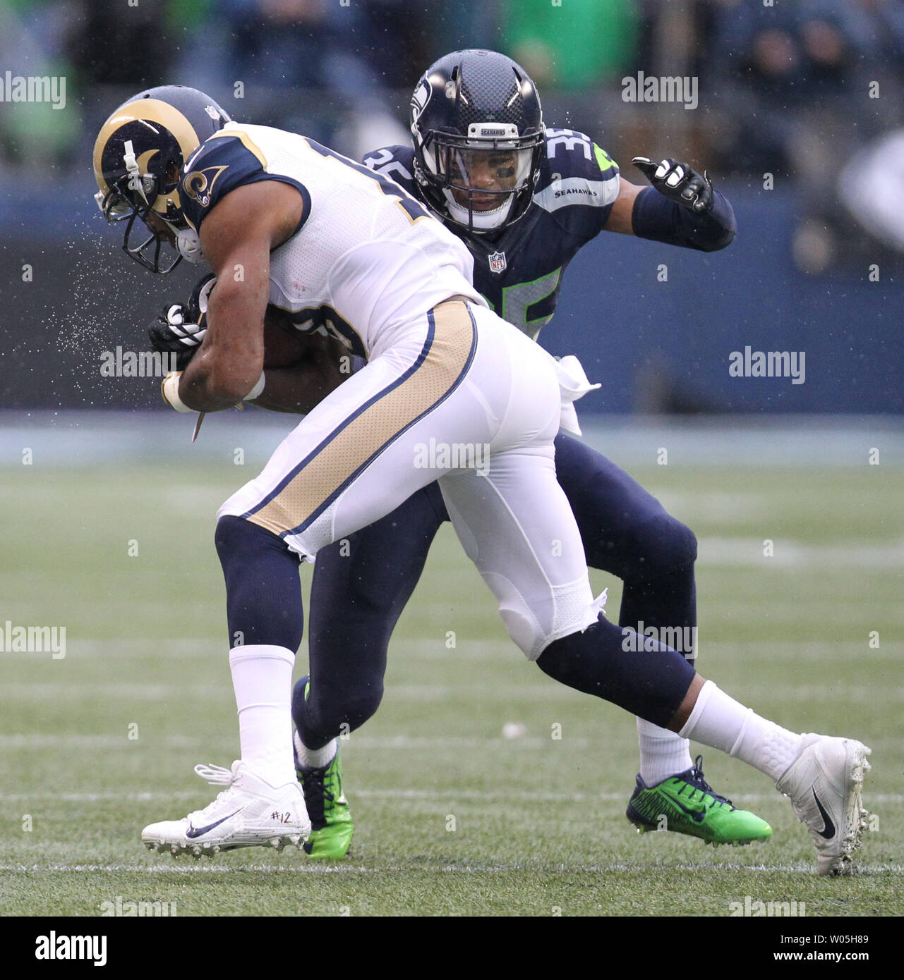 Seattle Seahawks cornerback DeShawn Snead (35) tackles St. Louis Rams wide  receiver Kenny Britt (18) at