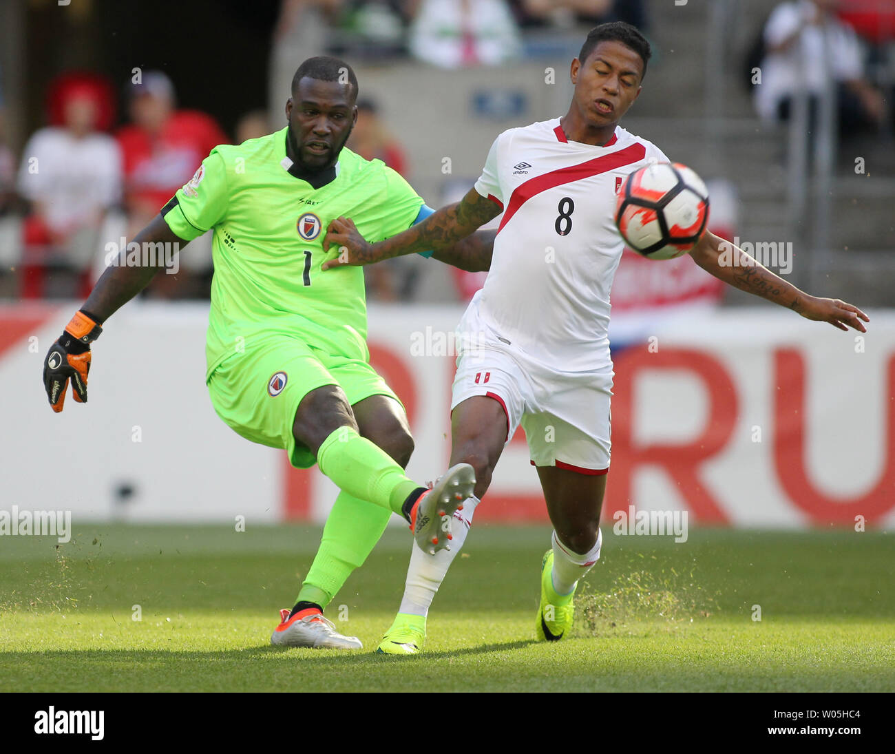 Haiti goalie Johny Placide (1) kicks the ball away from Peru's Andy Polo  (8) in a 2016 Copa America Centenario soccer match at CenturyLink Field in  Seattle, Washington on June 4, 2016.