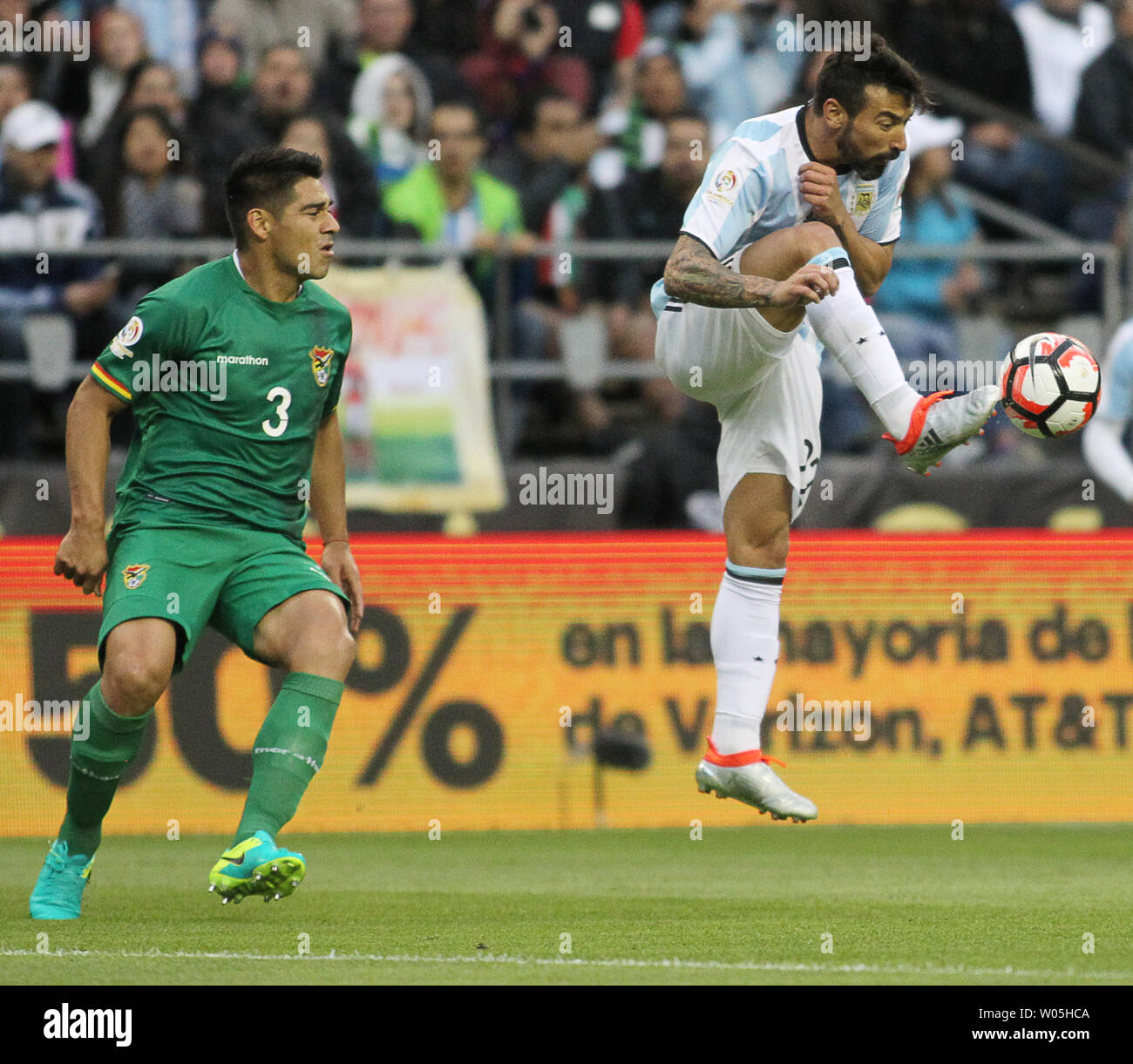 Argentina's Ezequiet Lavezzi (22) boots the ball away from Bolivia's Facundo Roncaglia (3) in a 2016 Copa America Centenario soccer match at CenturyLink Field in Seattle, Washington on June 14, 2016.  Lavezzi scored a first half gaol a in Argentina's 3-0 win over Bolivia.   Photo by Jim Bryant/ UPI Stock Photo