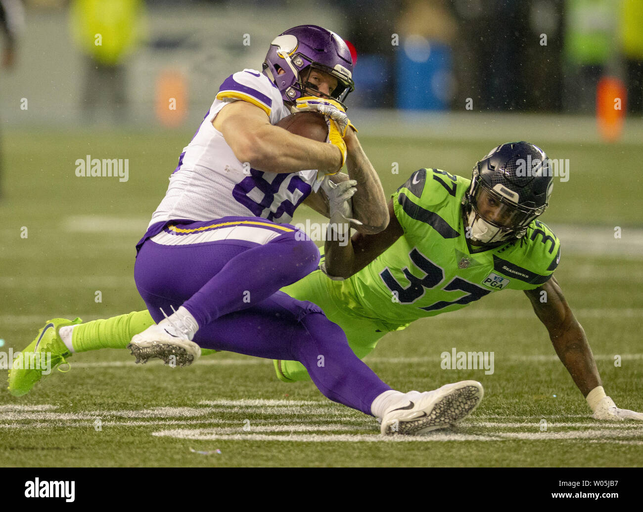 Minnesota Vikings tight end Kyle Rudolph (82) is taken down by Seattle Seahawks cornerback Tre Flowers (37) after catching a five-yard pass during the third quarter at CenturyLink Field on December 10, 2018 in Seattle, Washington.  The Seahawks beat the Vikings 21-7.       Photo by Jim Bryant/UPI Stock Photo