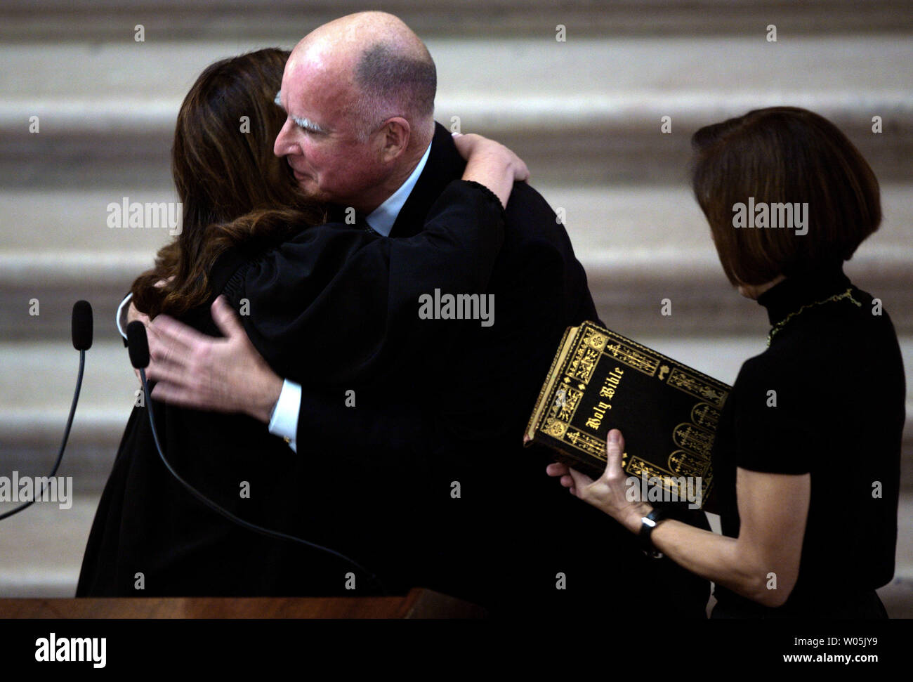 California Attorney General Edmund G. Brown Jr. gives a hug to Superior