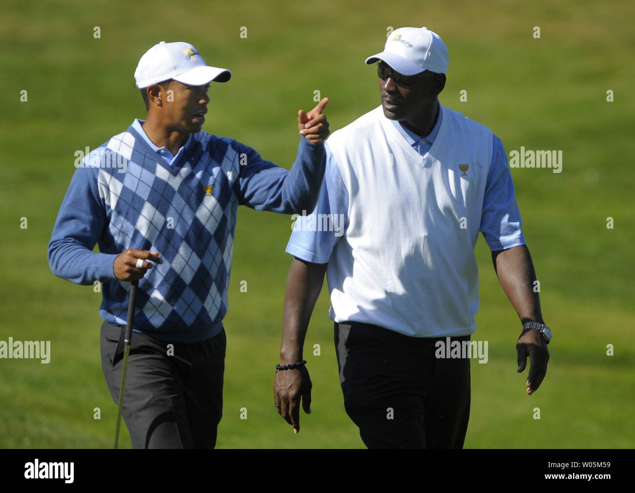 Tiger Woods (L) talks to basketball legend Michael Jordan as they walk down the 15th fairway during a practice round prior to the start of The Presidents Cup at Harding Park Golf Course in San Francisco, California on October 7, 2009.    UPI/Kevin Dietsch Stock Photo