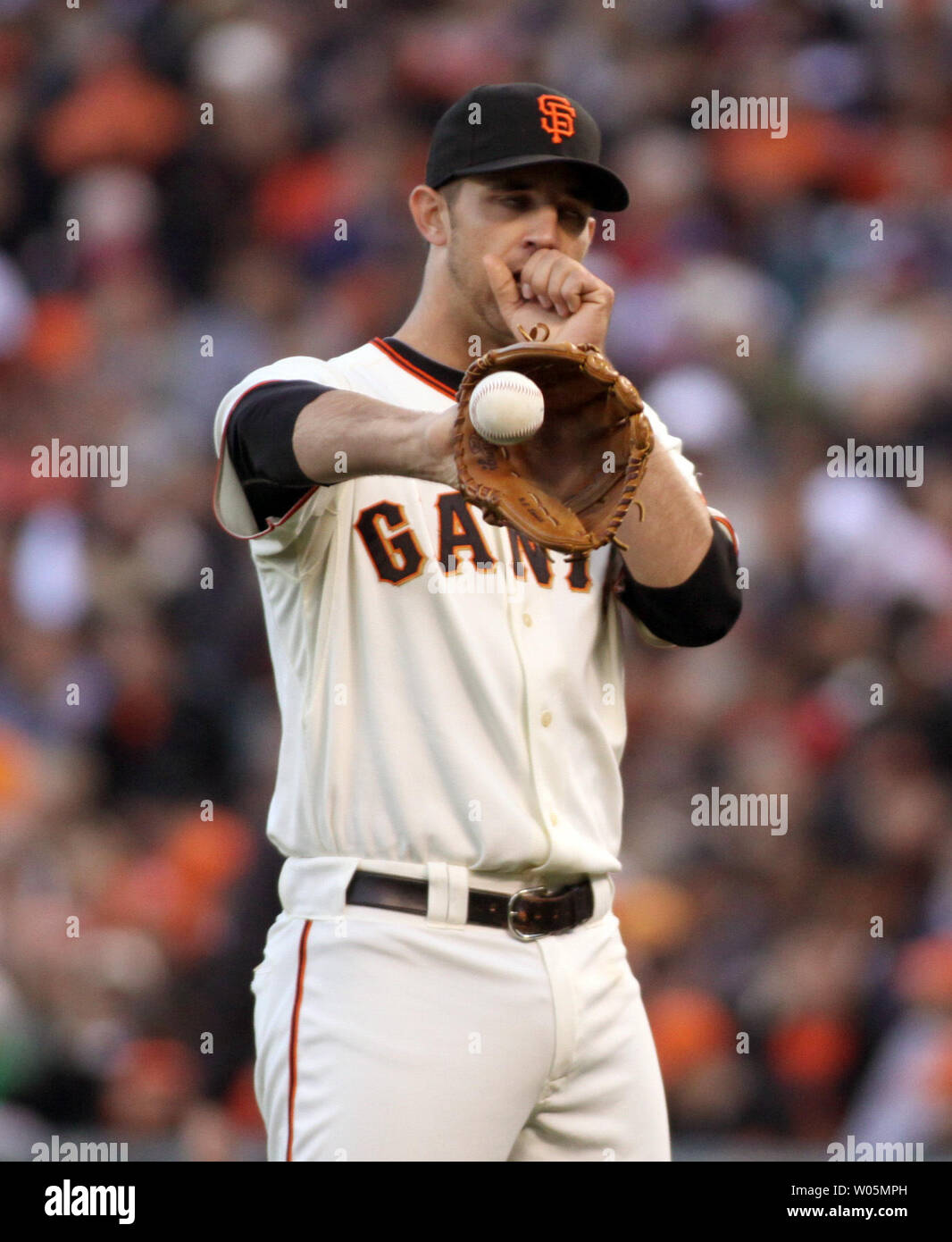 San Francisco Giants Madison Bumgarner blows on his hand during