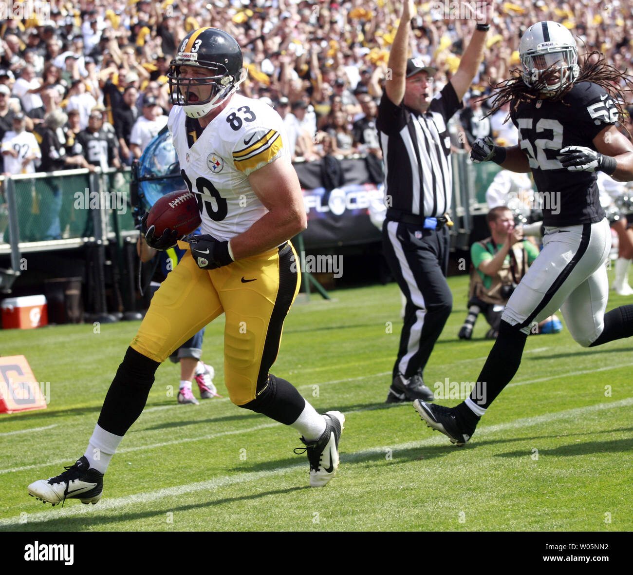Pittsburg Steelers TE Heath Miller shouts after catching a pass from Ben Roethlisberger and running 4 yds for a first quarter touchdown chased by Oakland Raiders LB Philip Wheeler at O.co Coliseum in Oakland, California on September 23, 2012.   Raiders defeated the Steelers 34-31.      UPI/Bruce Gordon Stock Photo