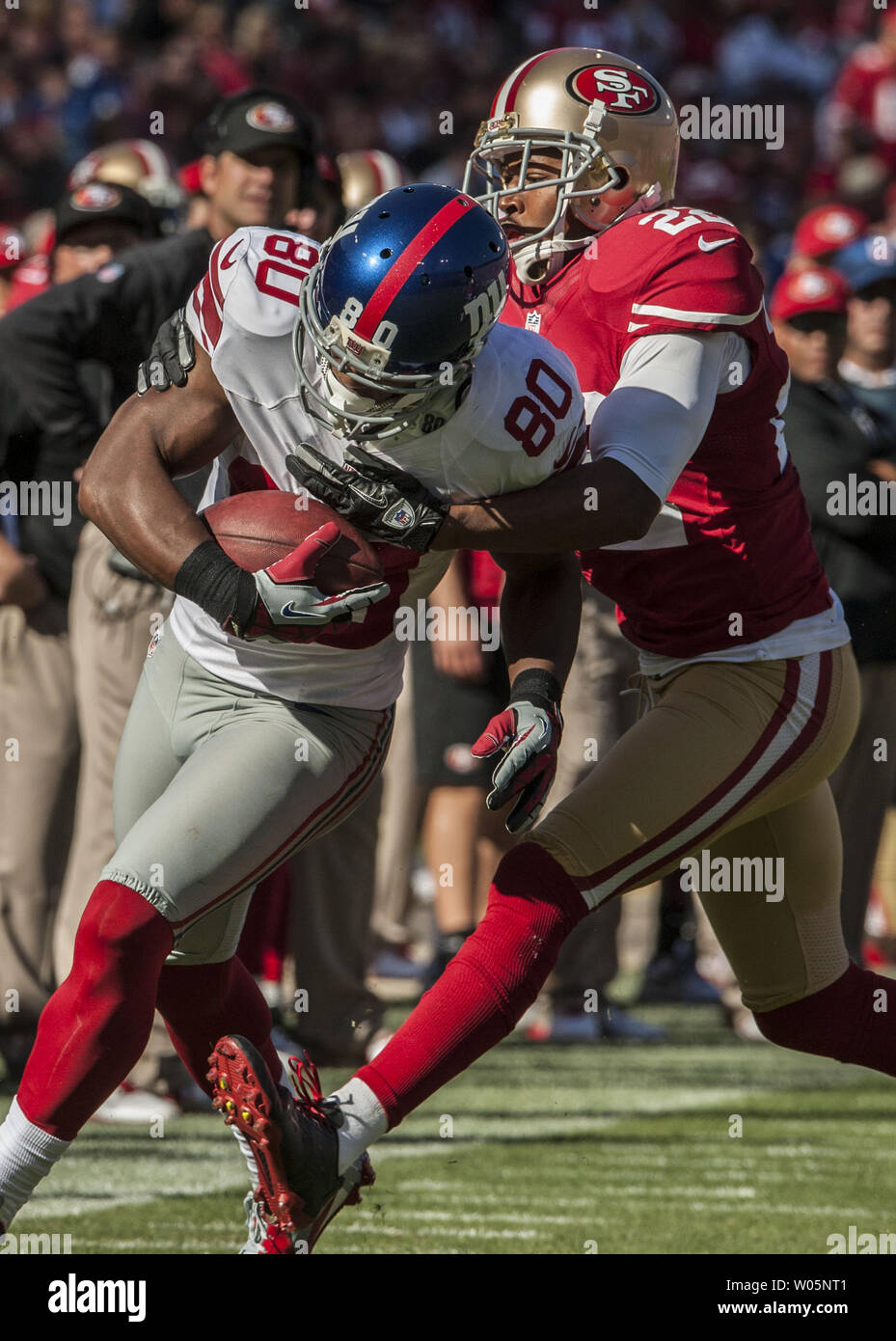 San Francisco 49ers cornerback Carlos Rogers (22) tackles New York Giants wide receiver Victor Cruz (80) in third quarter at Candlestick Park in San Francisco on October 14, 2012.  The Giants defeated the 49ers 26-3.    UPI/Al Golub. Stock Photo
