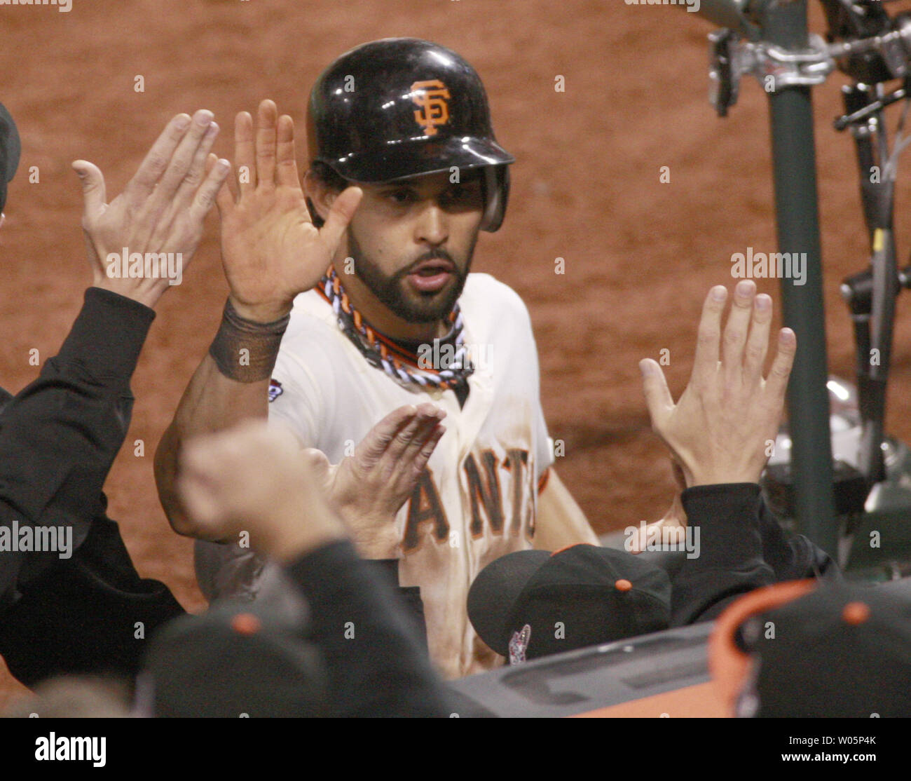 San Francisco Giants Angel Pagan gets high fives at the dugout after scoring on a sacrifice fly by Hunter Pence in the eighth inning against the Detroit Tigers in game two of the World Series at AT&T Park in San Francisco on October 25, 2012.  The Giants defeated the Tigers 2-0.   UPI/Bruce Gordon Stock Photo