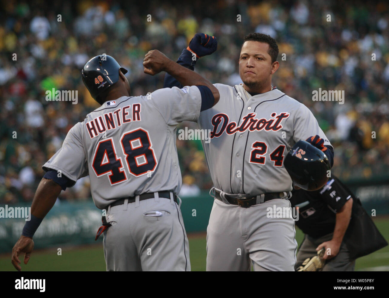 Detroit Tigers Miguel Cabrera (24) celebrates a fourth inning two run home run off Oakland A's Sonny Gray with Tigers Tori Hunter (48) in game 5 of the American League Division Series at O.co Coliseum in Oakland, California on October 10, 2013.     UPI/Bruce Gordon Stock Photo