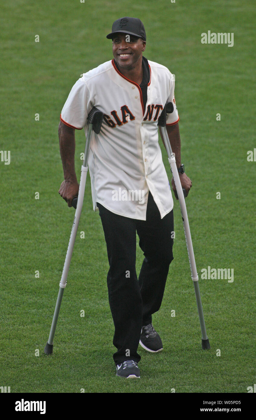 San Francisco Giants great Barry Bonds walks on crutches after throwing out the ceremonial first pitch before the San Francisco Giants played the St. Louis Cardinals in game 4 of the National League Championship Series at AT&T Park in San Francisco on October 15, 2014. The Giants defeated the cardinals 6-4 to go up 3 games to 1.      UPI/Bruce Gordon Stock Photo
