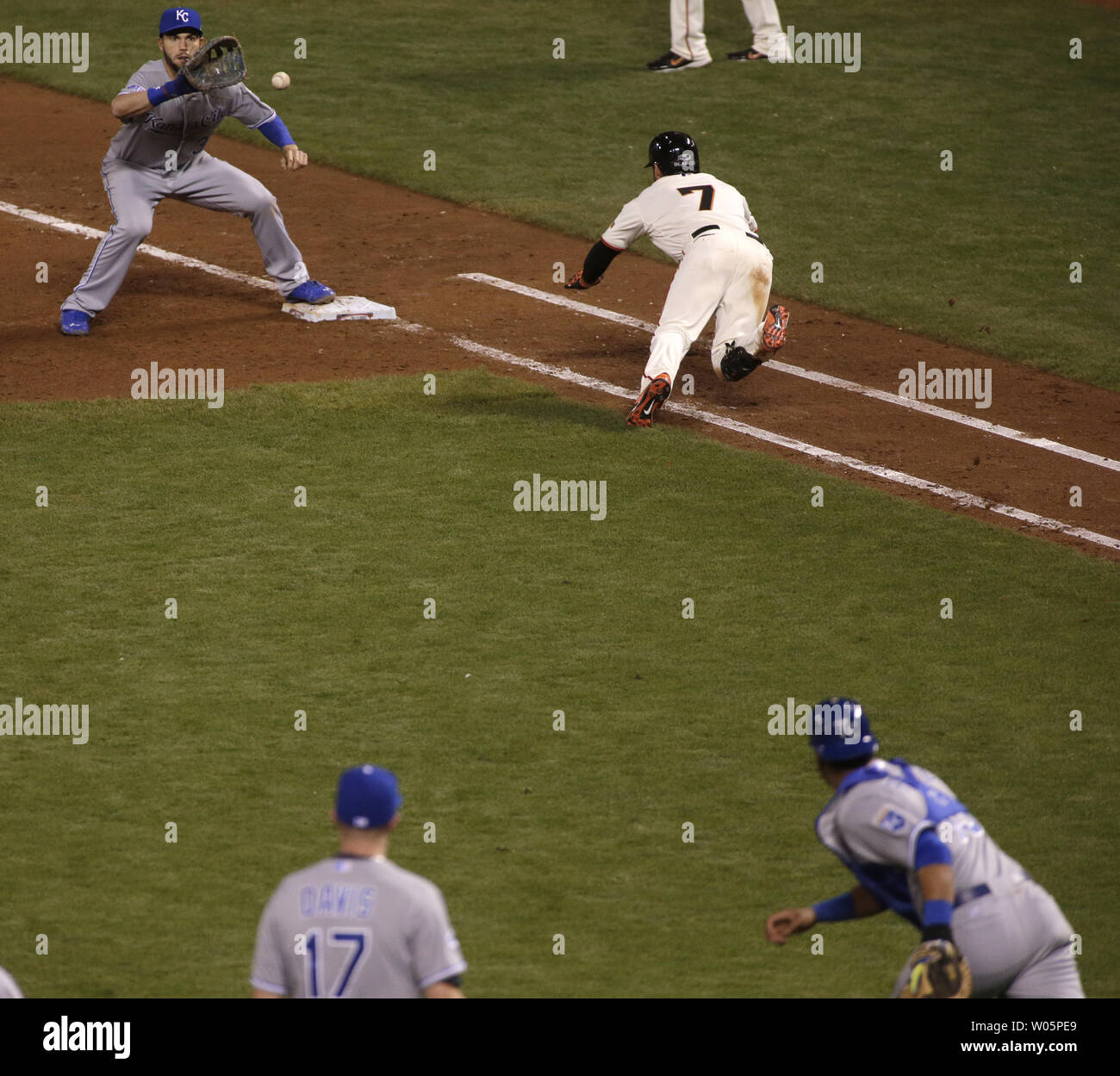 Kansas City Royals 1B Eric Hosmer takes the throw from catcher Salvador Perez (R)  to nail San Francisco Giants Gregor Blanco who bunted off pitcher Wade Davis (17) in the eighth inning of game 3 of the World Series at AT&T Park in San Francisco on October 24, 2014. The Royals defeated the Giants 3-2 to go up 2 games to 1 in the series.    UPI/Bruce Gordon Stock Photo