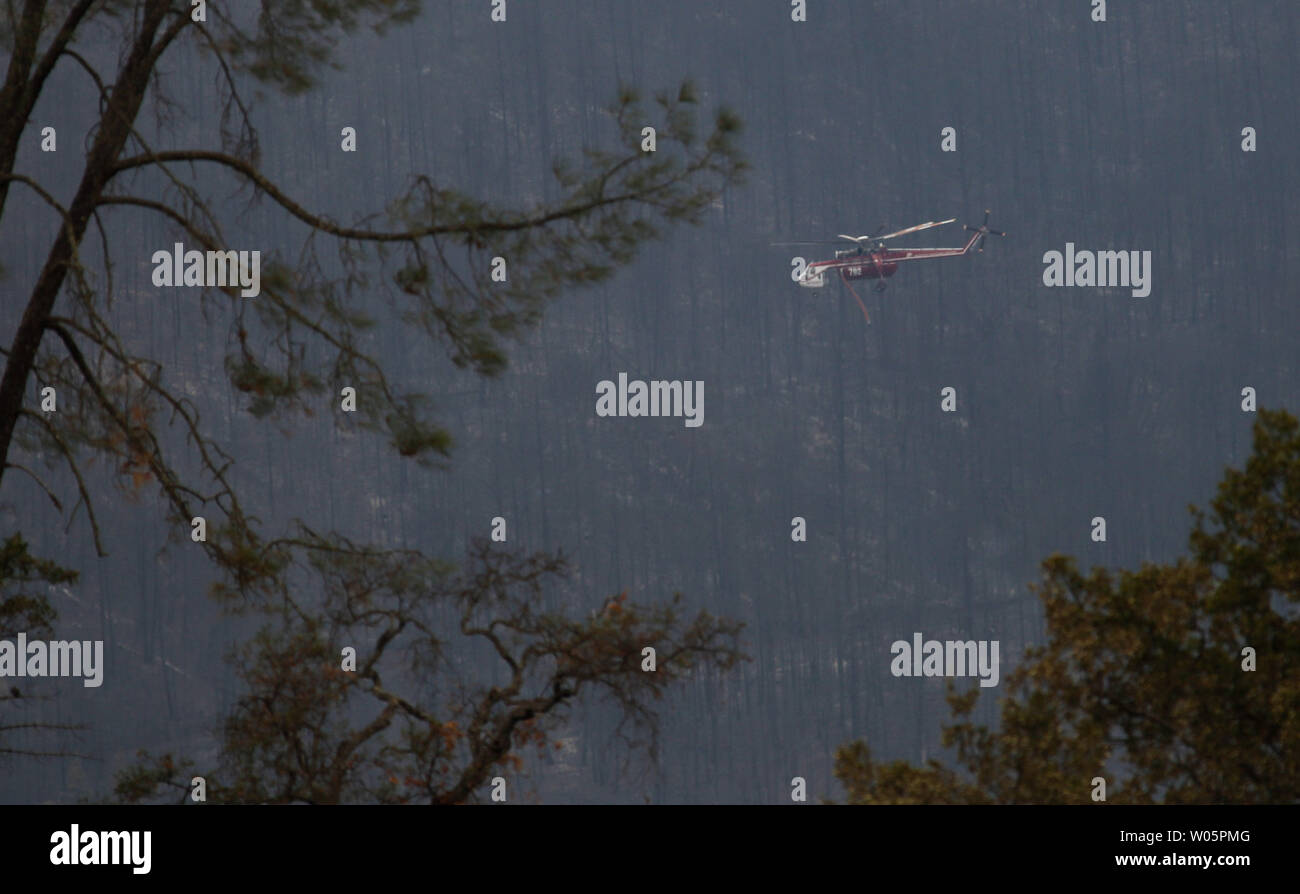 A specialized helicopter flies the burned terrain during the Valley ...