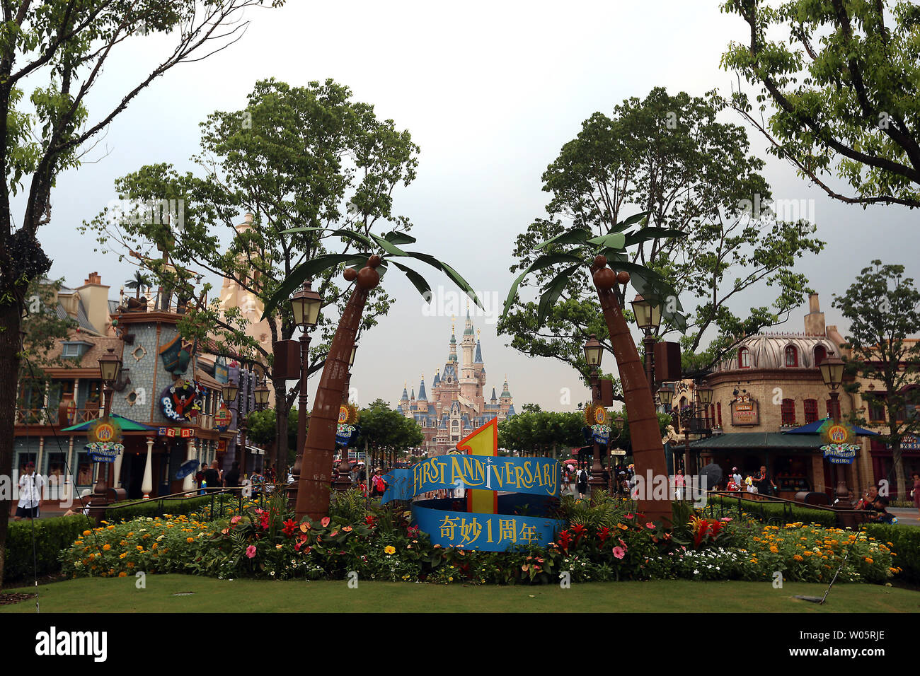 A few tourists walk along the main street headed to the rides and castle in Shanghai Disney Resort on August 14, 2017.  Shanghai Disneyland is the company's largest foreign investment and is targeting China's rapidly growing middle class - a key to the company's future, according to Disney.       Photo by Stephen Shaver/UPI Stock Photo