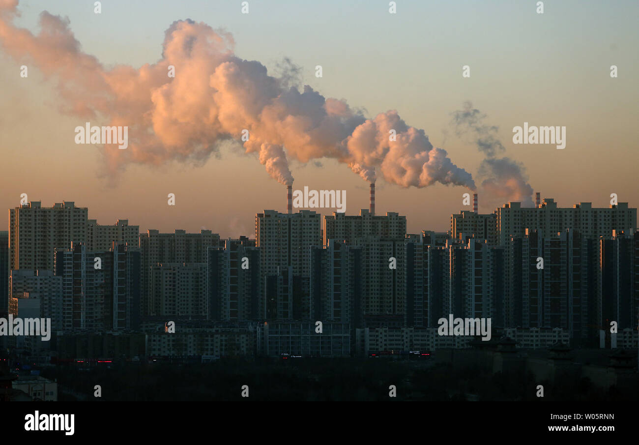 Smoke billows from coal-powered electric power plants in Datong, Shanxi Province (China's coal country), on December 12, 2018.  China is the largest producer and consumer of coal in the world, making it the leading emitter of greenhouse gases from coal.  China burns much more coal than reported, which has continued to complicate climate talks.    Photo by Stephen Shaver/UPI.. Stock Photo