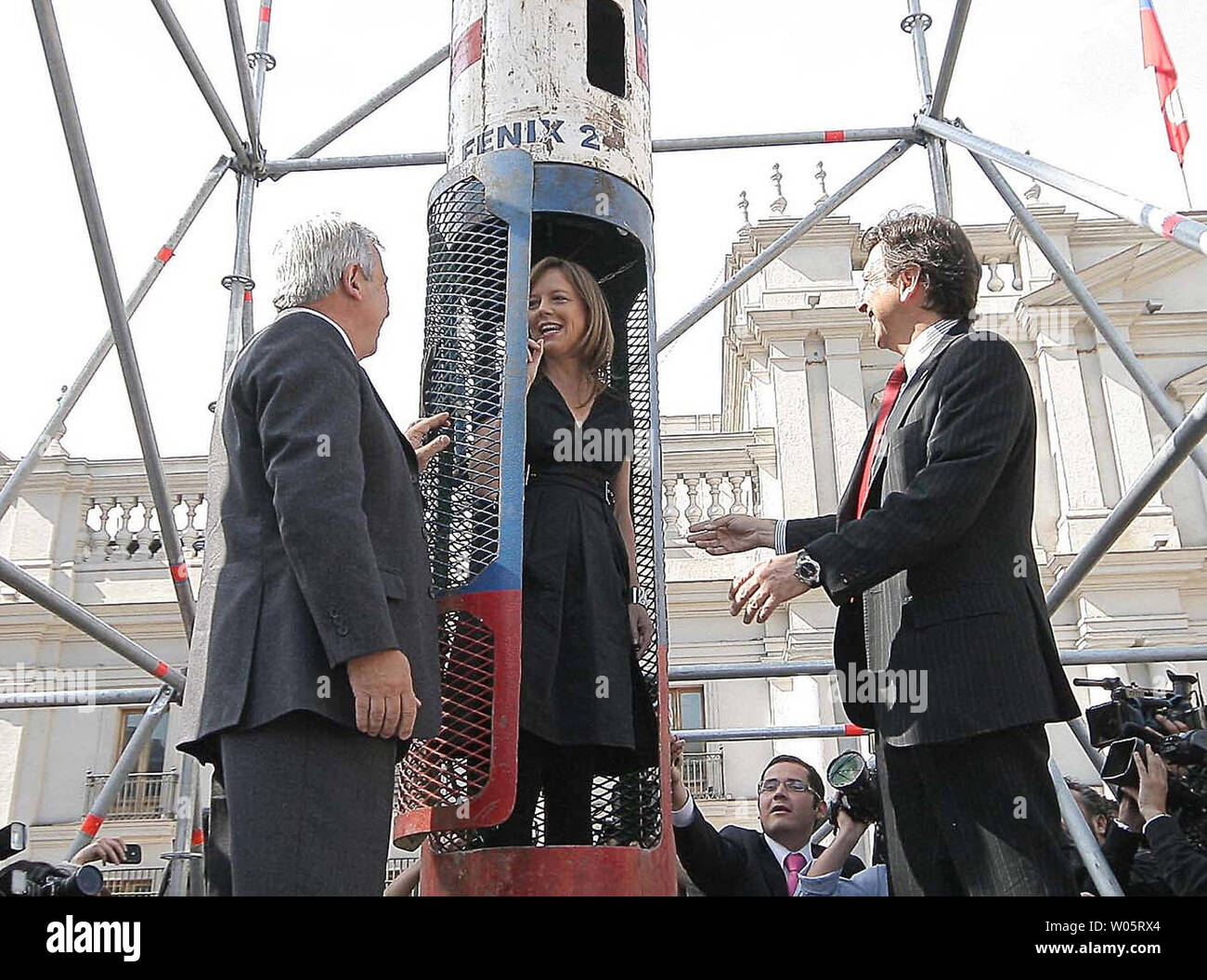 Chile's Health Minister Jaime Ma–alich, Ministry General Secretariat of Government Ena von Baer and Mining Minister Laurence Golborne (L to R) are on hand to view an exhibit with the Phoenix 2 capsule which was used to rescue 33 trapped miners in Santiago, Chile, on October 19, 2010.   UPI/Pedro Cerda. Stock Photo