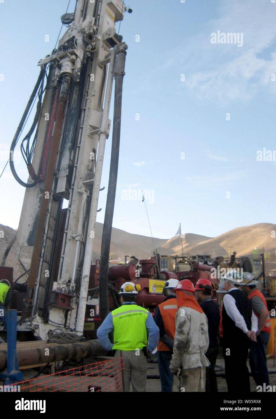 Mining engineers look at the drilling machine as it bores through the earth to within 500 feet of the trapped miners in San Jose Mine, Chile on October 4, 2010.  Chilean President Sebastian Pinera said the rescue efforts were expected to pull the 33 miners to safety by the end of the month.  The miners were found alive on August 22nd after a mine collapse.    UPI/Sebastian Padilla Stock Photo