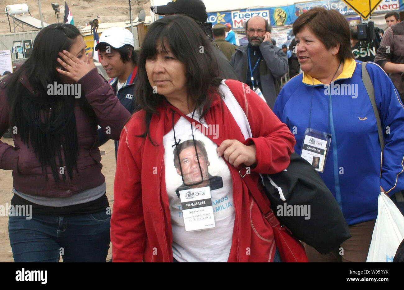 Relatives have T-Shirts with pictures of their loved ones as preparations continue to rescue the 33 trapped miners at San Jose Mine, Chile on October 11, 2010.   If all goes well, officials say the first miners will be brought up in a few days via a 20-minute ride in a rescue capsule more than 2,000 feet below the surface.   The miners have been trapped for more than two months.   UPI/Sebastian Padilla Stock Photo