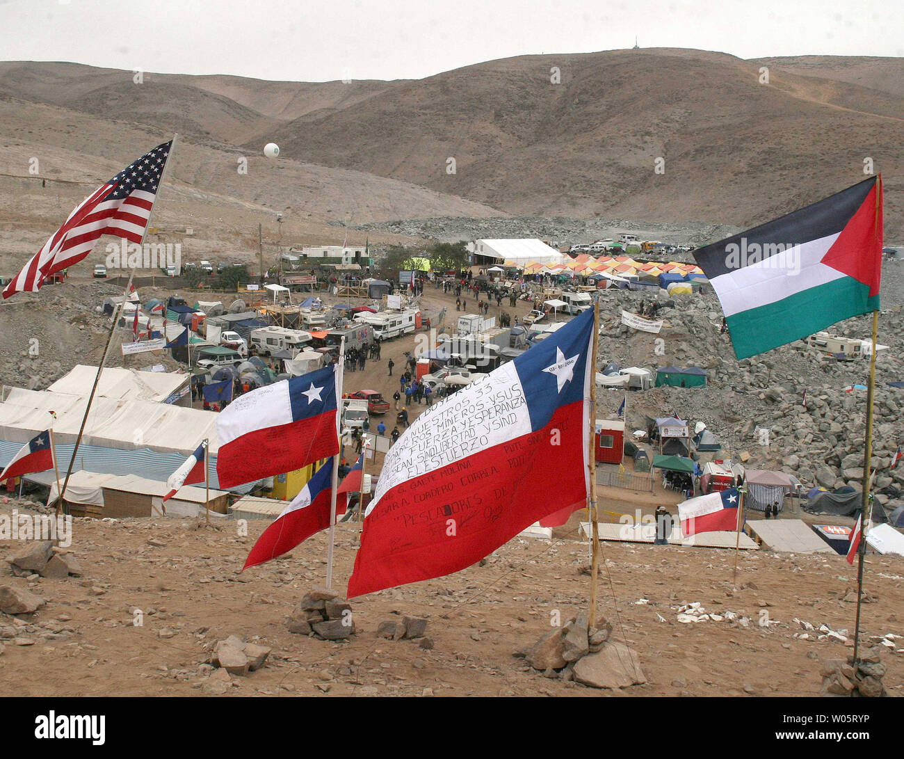 Flags adorn a hill at Camp Hope as preparations continue to rescue the 33 trapped miners at San Jose Mine, Chile on October 11, 2010.   If all goes well, officials say the first miners will be brought up in a few days via a 20-minute ride in a rescue capsule more than 2,000 feet below the surface.   The miners have been trapped for more than two months.   UPI/Sebastian Padilla Stock Photo