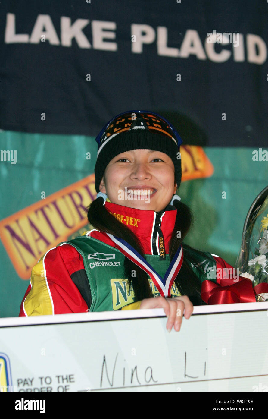 Chinese aerialist LI Nina, 22, accepts a gold medal and cheque for winning the Freestyle World Cup event in Lake Placid, NY on January 14, 2005.  Miss Li of Shenyang, China, tallied 96.56 points ahead of Australian Lydia Ierodiaconou (94.25), who leads the world cup standings.  (UPI Photo / Grace Chiu) Stock Photo