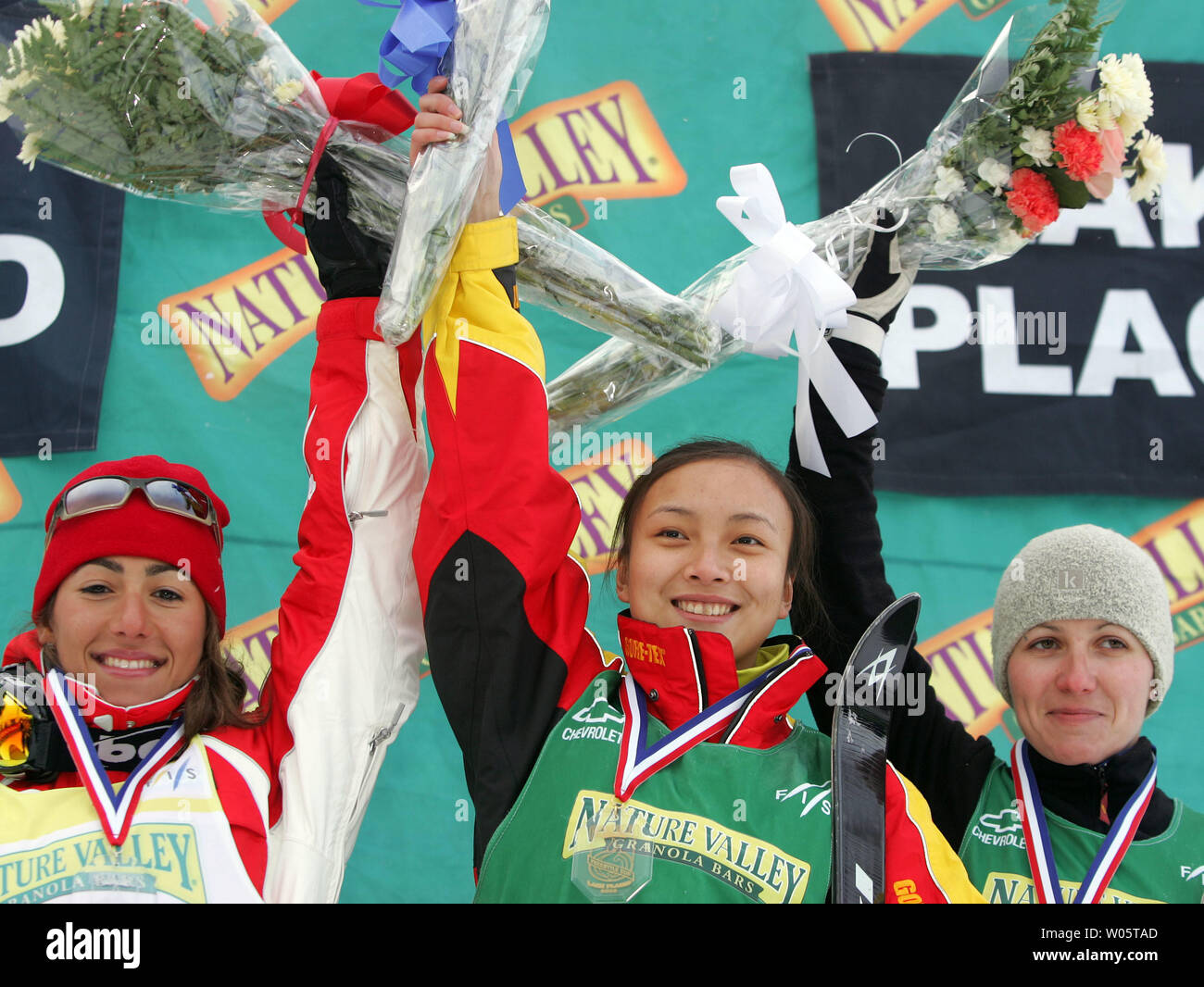 (L-R) Women's aerialists Lydia Ierodiaconou of Australia, Nina Li of China, and Alla Tsuper of Belarus celebrate winning silver, gold, and bronze medals, respectively, at the Freestyle World Cup event in Lake Placid, NY on January 16, 2005.  Miss Li, who comes from Shenyang, China, totalled 186.72 points in two jumps to win over #1-ranked Ierodiaconou (186.01) and Tsuper (1176.19). (UPI Photo/Grace Chiu) Stock Photo