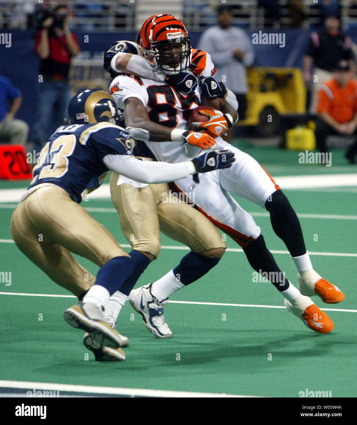 St. Louis Rams' Jerametrius Butler (L) and Aeneas Williams, corral Cincinnati Bengals' Tony Stewart for the tackle in the second quarter at the Edward Jones Dome in St. Louis on December 21, 2003. (UPI Photo/Bill Greenblatt) Stock Photo