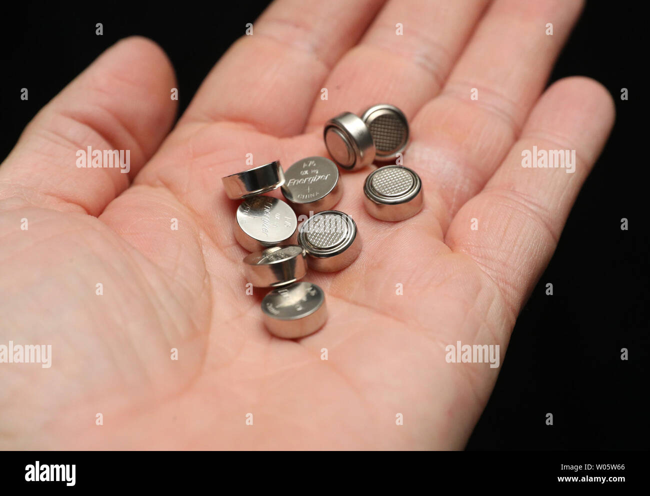 EMBARGOED TO 1000 THURSDAY JUNE 27 A person holds a pile of Energizer  LR44/A76 Alkaline 1.5v batteries in their hand. The death of a child who  swallowed a button battery has led