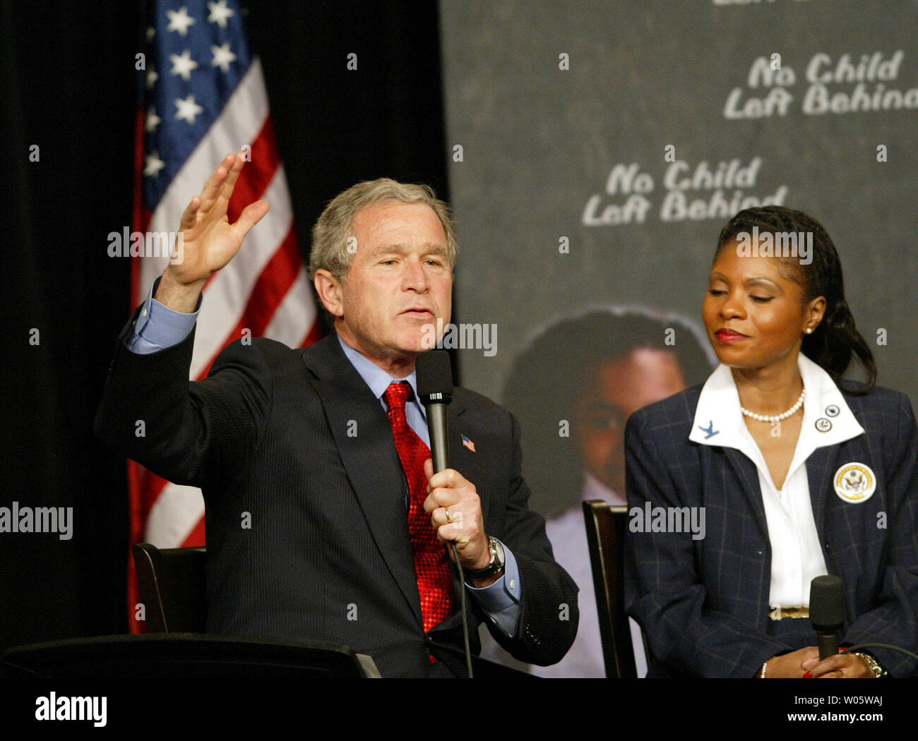 President Bush makes a point as Pierre Laclede Elementary School principal Yolanda Moss