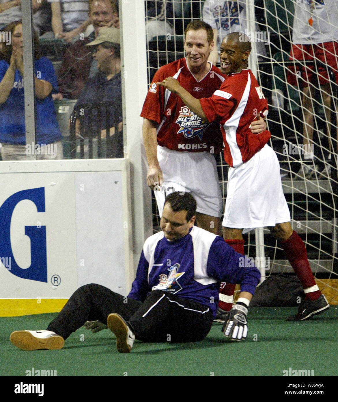 USA Team members Paul Wright of the San Diego Sockers (R) celebrates his unassisted goal with teammember Mikchael King of the Milwaukee Wave past the unhappy International Team goalkeeper Peter Pappas of the Philadelphia KiXX in the third quarter of the Major Indoor Soccer League's 2004 All Star Game at the Family Arena in St. Charles, MO on February 29, 2004. Team USA won the game 10-1. (UPI Photo/Bill Greenblatt) Stock Photo