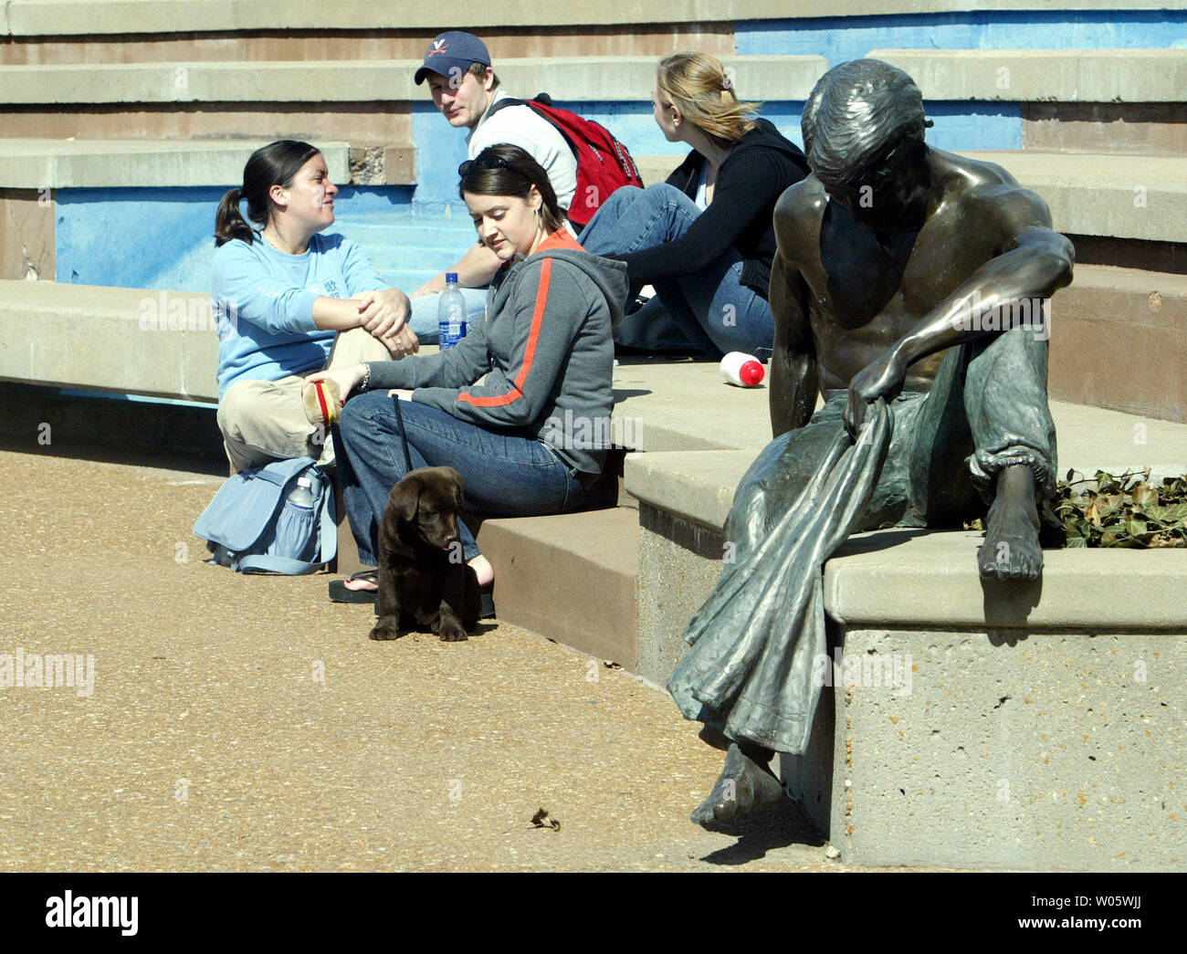 Students and statues at Saint Louis University enjoy the warm sun outside as temperatures reach 71 degrees in St. Louis on March 1, 2004. Forcasters say cooler weather along with showers are planned for the next couple days.(UPI Photo/Bill Greenblatt) Stock Photo