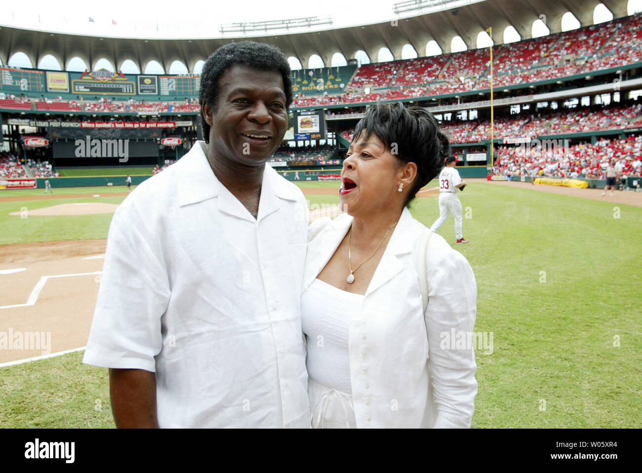 Baseball Hall of Famer and former St. Louis Cardinals great Lou Brock and  his wife Jackie talk to fans on the field before a game between the  Cardinals and the Boston Red