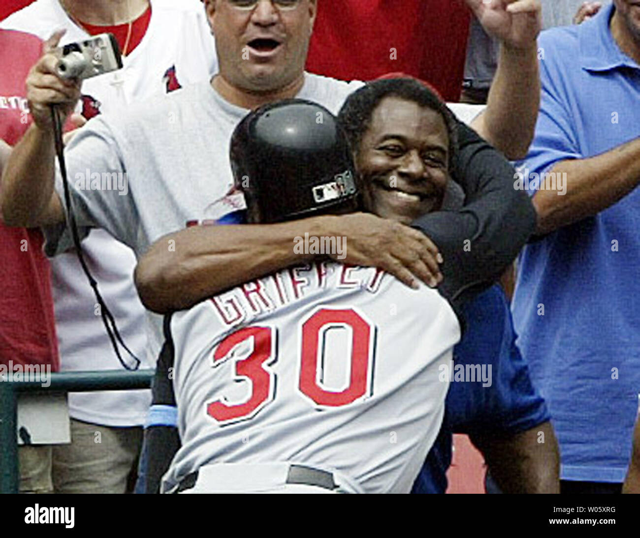 Cincinnati Reds Ken Griffey Jr. gets a hug from his father Ken Griffey Sr.  after the younger Griffey smacked his 500th career home run in the sixth  inning, against the St. Louis