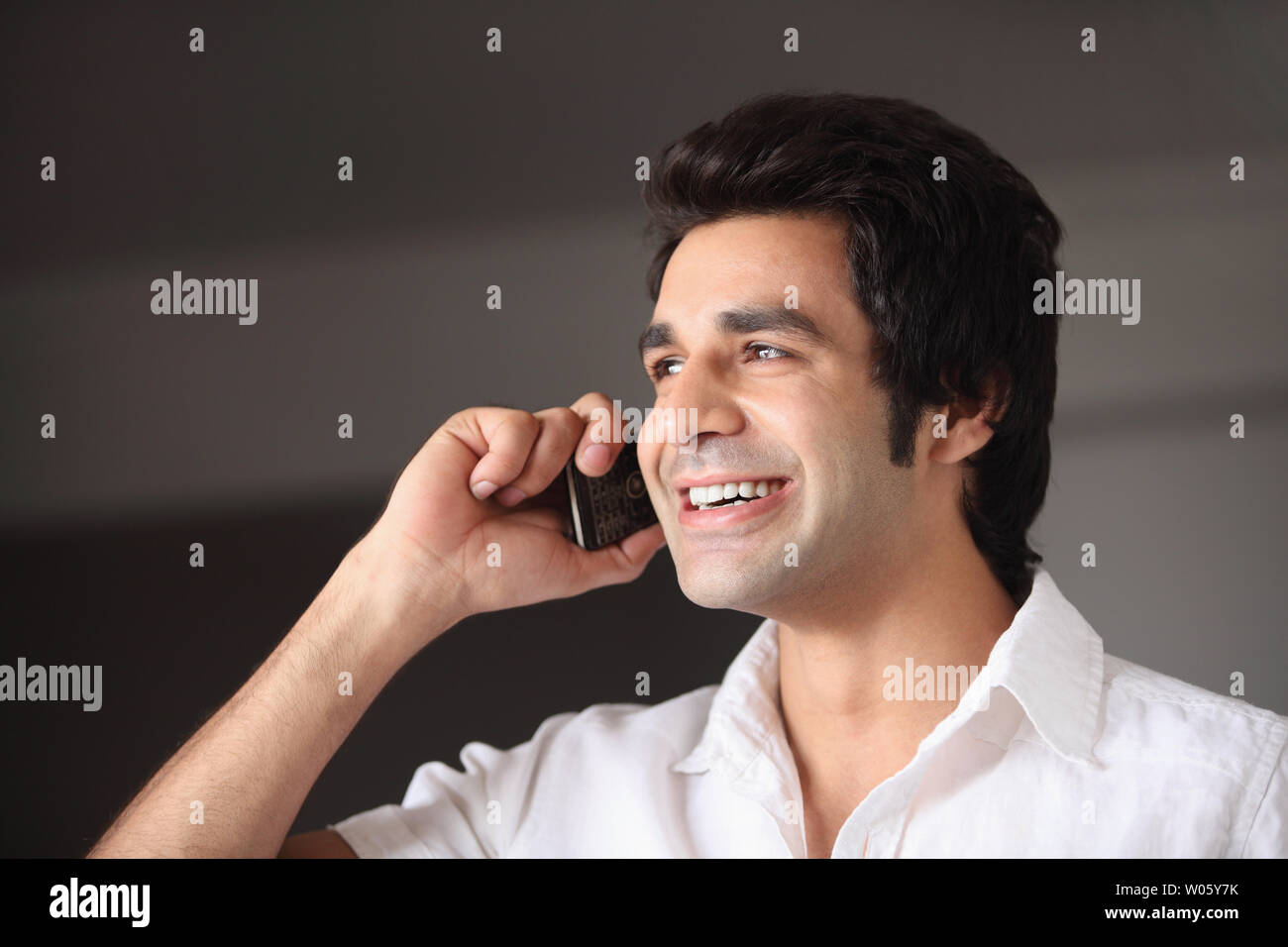 Close up of an Indian man talking on a mobile phone Stock Photo - Alamy