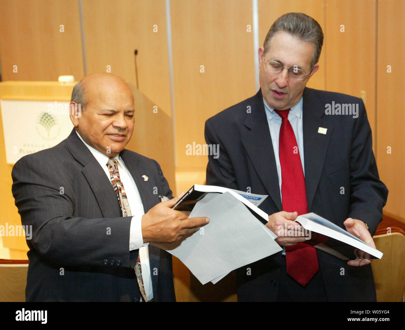 Dr. Surendra Gupta, Ph.D., president of the St. Louis-based American Radiolabeled Chemicals, Inc. (L) shows his product catalogue to E. Anthony Wayne, U.S. Assistant Secretary of State before receiving the Export Achievement Certificate by the U.S. Department of Commerce at the Danforth Plant Science Center in Creve Coeur, Mo on October 1, 2004. American Radiolabeled Chemicals, Inc. specializes in the production and worldwide distribution of a wide variety of radiochemicals for drug metabolism studies. It is ranked third in the world for overall sales and first in the number and type of produc Stock Photo