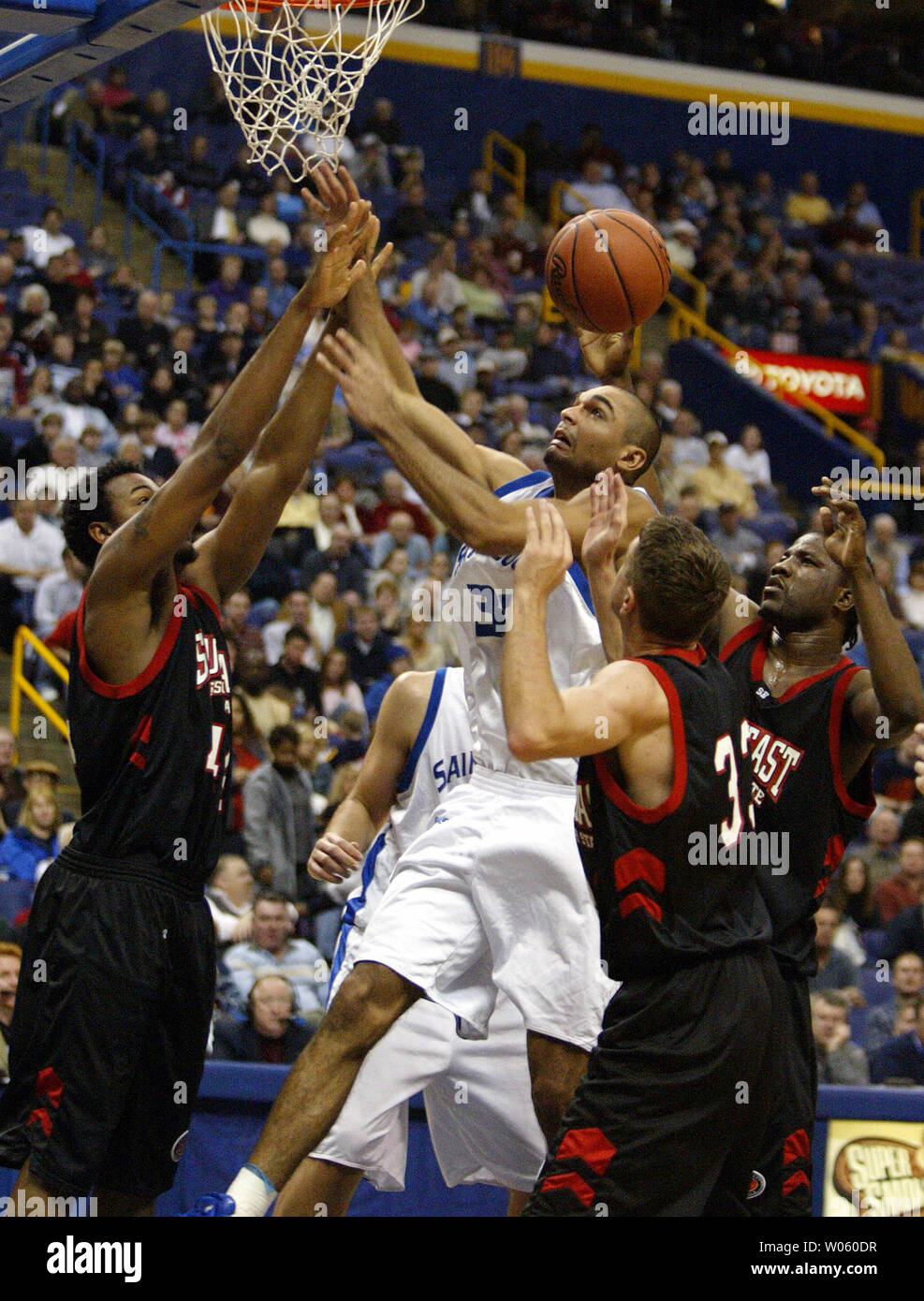 Saint Louis University Billikens Izik Ohanon (30) loses control of the basketball during a rebound attempt while being triple teamed by Southeast Missouri State Indians' (L to R) Waylon Francis, Dainmon Gonner and Derek Winans in the first half at the Savvis Center in St. Louis on December 29, 2004.   (UPI Photo/Bill Greenblatt) Stock Photo