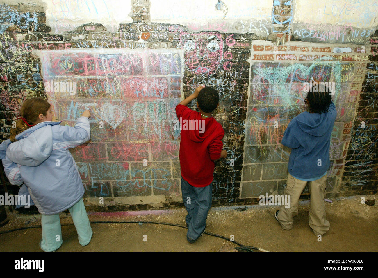 Children try their artistic abilities as they do graffiti murals during First Night St. Louis in St. Louis on December 31, 2004. First Night St. Louis is a alcohol-free, visual and performing arts festival geared toward family oriented actvities to welcome the New Year. (UPI Photo/Bill Greenblatt) Stock Photo