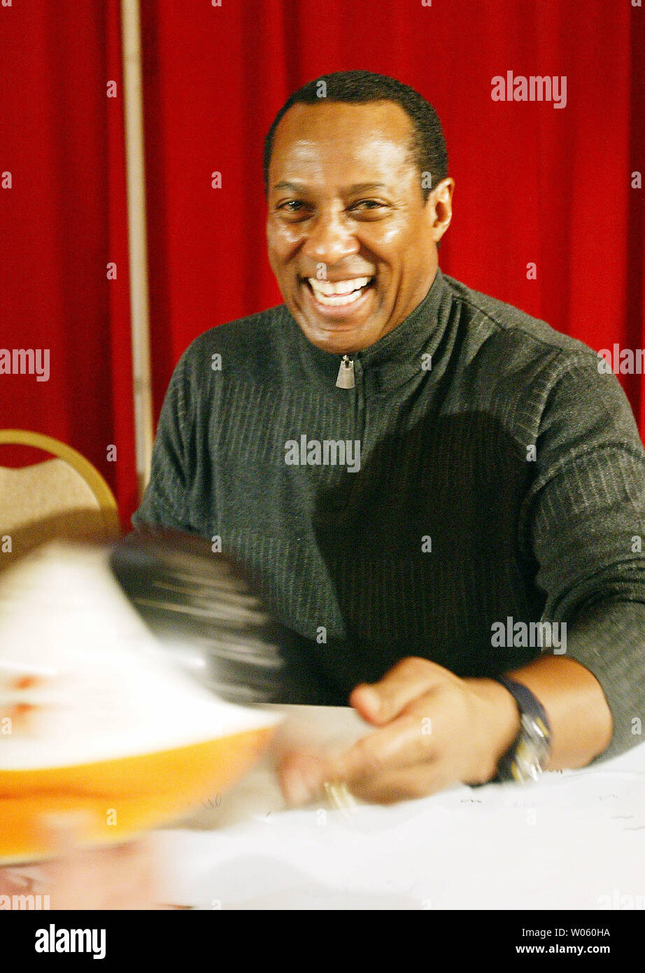 Former St. Louis Cardinals outfielder Tito Landrum smiles as he signs a helmet for a fan during the 9th Annual St. Louis Cardinals Winter Warm-up at the Millennium Hotel in St. Louis on January 17, 2005. The three-day event allows fans to see their favorite Cardinals players, get their autographs and participate in various games and activities. (UPI Photo/Bill Greenblatt) Stock Photo