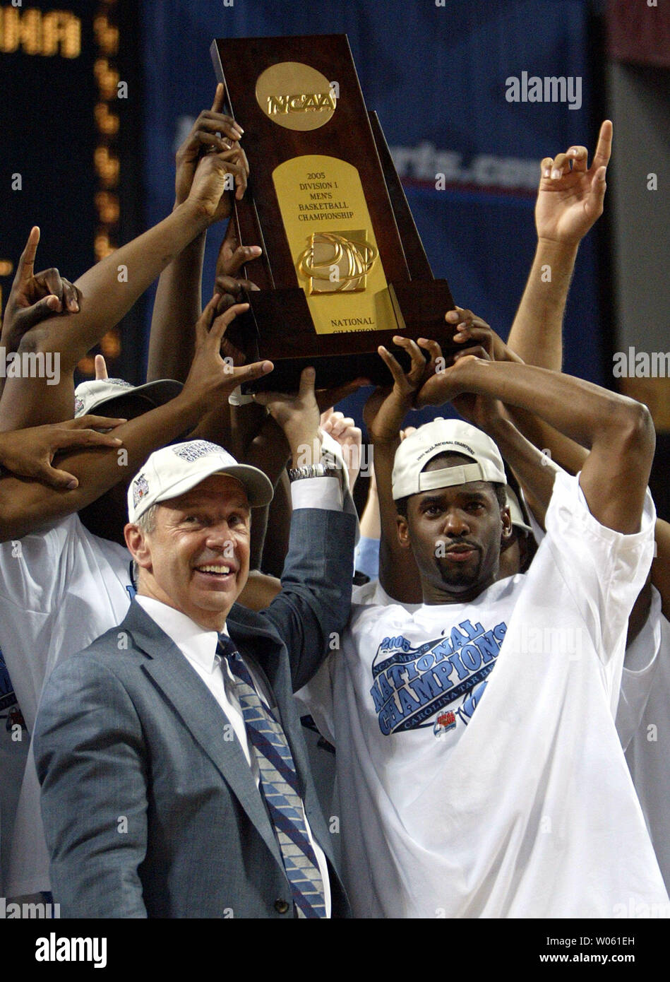 North Carolina head basketball coach Roy Williams (L) hoists the NCAA Mens  National Basketball Championship Trophy after defeating Illinois, 75-70 at  the Edward Jones Dome in St. Louis on April 4, 2005. (