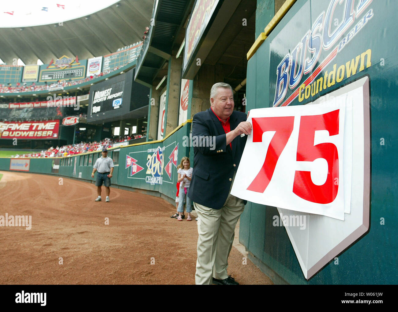 NBC Television announcer Jay Randolph peals off a large 75 offf off the right field wall at Busch Stadium during a game between the Chicago Cubs and the St. Louis Cardinals in St. Louis on April 21, 2005. After this game there is only 74 games left in this Busch Stadium, scheduled for demolition in November.    (UPI Photo/Bill Greenblatt) Stock Photo