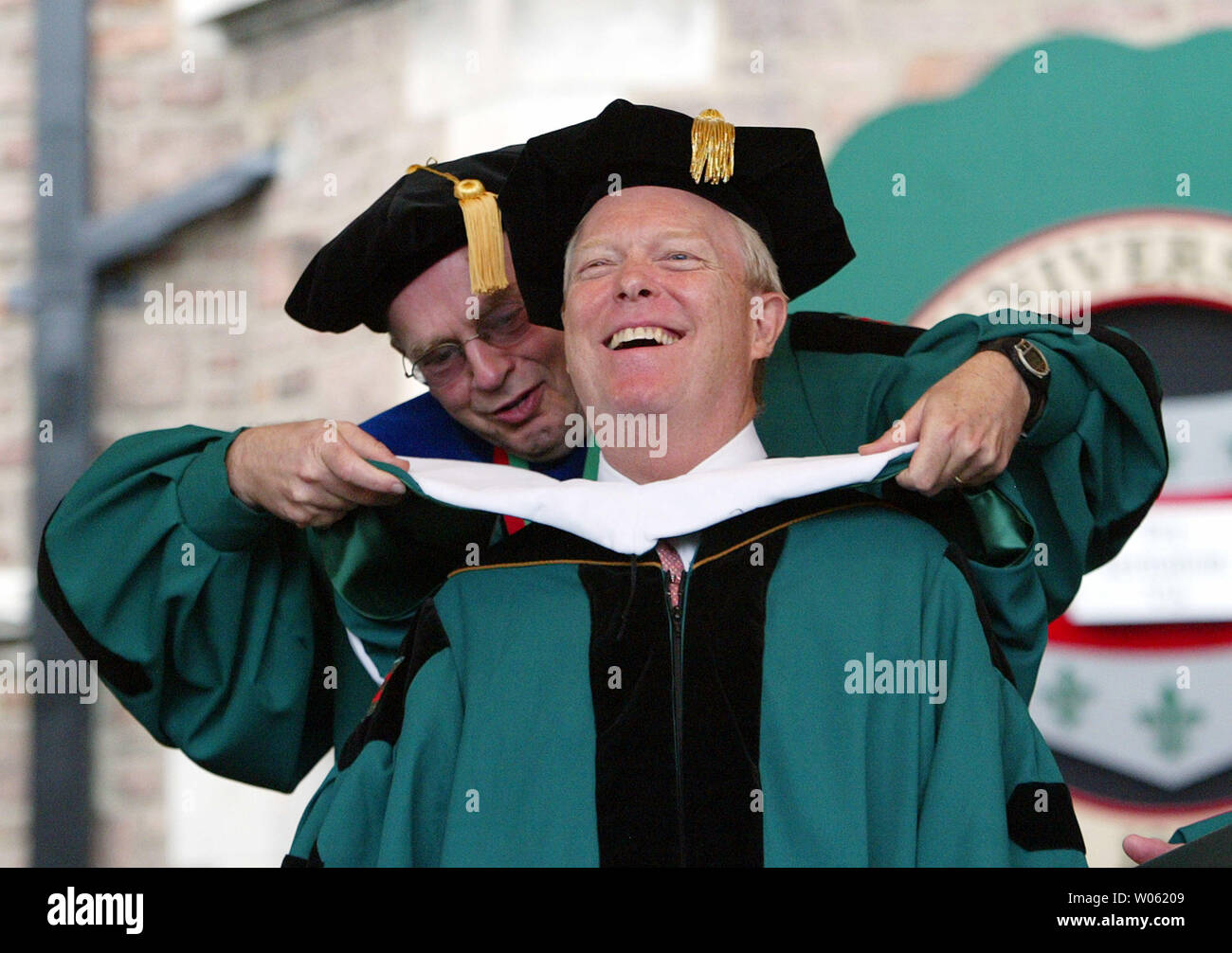 Former U.S. Rep. Richard Gephardt is hooded by Edward Wilson (L) commencement grand marshall during the Washington University graduation ceremonies in St. Louis on May 20, 2005. Gephardt was presented with the Honorary Degree of Doctor of Humane Letters. Washington University is also home of the new Richard A. Gephardt Institute for Public Service. (UPI Photo/Bill Greenblatt) Stock Photo
