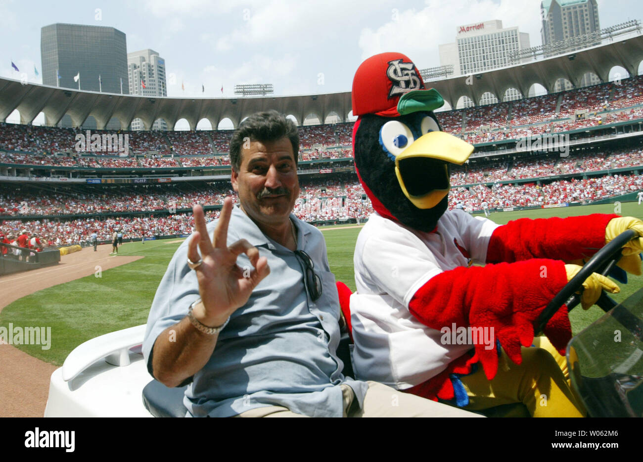 Former St. Louis Cardinals first baseman Keith Hernandez gets a ride from the Cardinals mascot Fredbird before pulling down the number 36 off of the Busch Stadium rightfield wall during a game against the Houston Astros in St. Louis on July 17, 2005. After today's game, only 35 will remain before St. Louis plays next year in a new facility next door. (UPI Photo/Bill Greenblatt) Stock Photo
