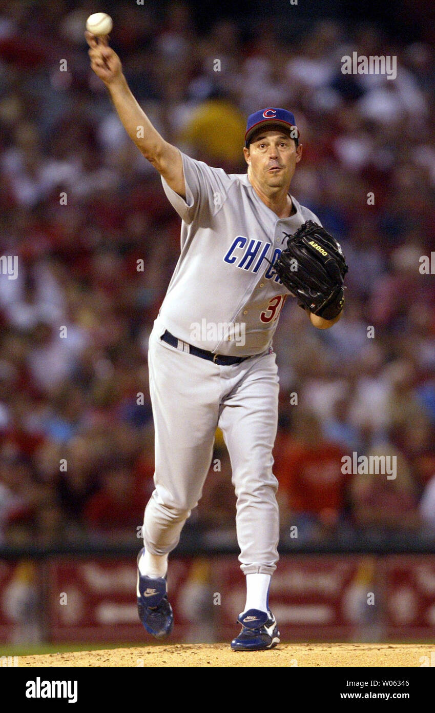 Chicago Cubs pitcher Greg Maddux throws to first base to pick off St