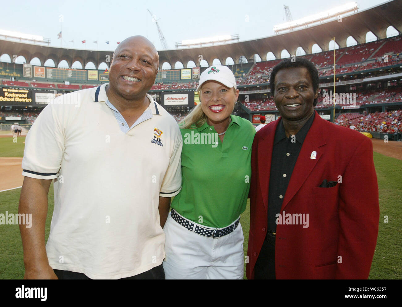 Former WBA heavyweight champion, James 'bonecrusher' Smith, professional golfer Michelle McGann and Baseball Hall of Famer Lou Brock (R) pose for a photo on the field at Busch Stadium before a game between the New York Mets and the St. Louis Cardinals in St. Louis on September 9, 2005. (UPI Photo/Bill Greenblatt) Stock Photo