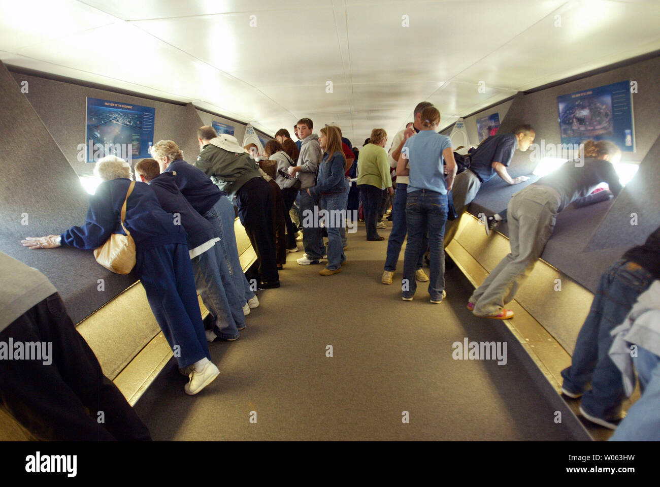 Visitors to the top of The Gateway Arch look out of the small windows  during its 40th birthday celebration in downton St. Louis on October 28,  2005. The tallest monument in the