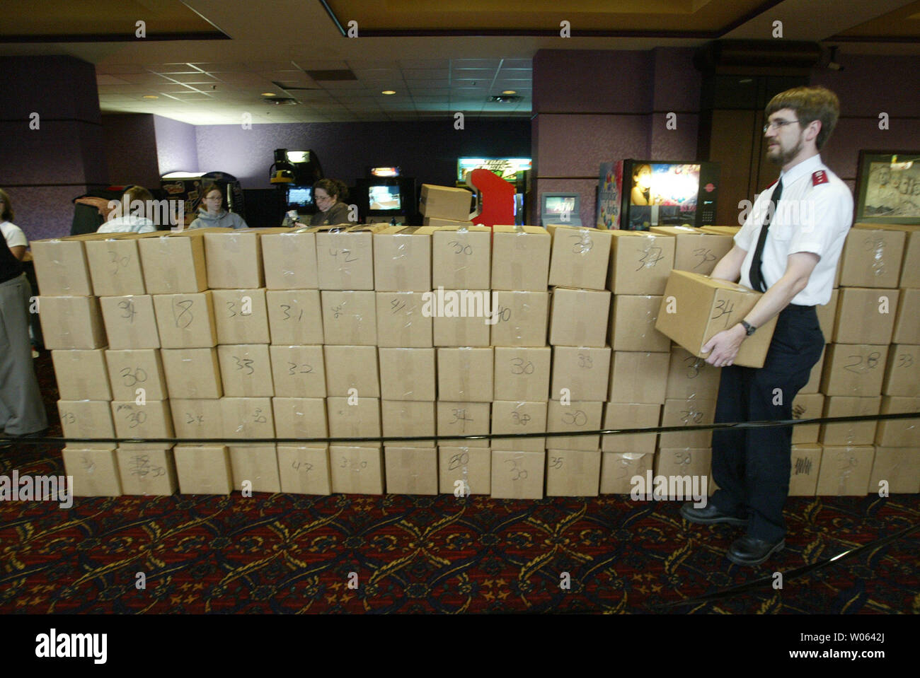 Salvation Army Capt. Brian Davis carries a box of canned goods as movie